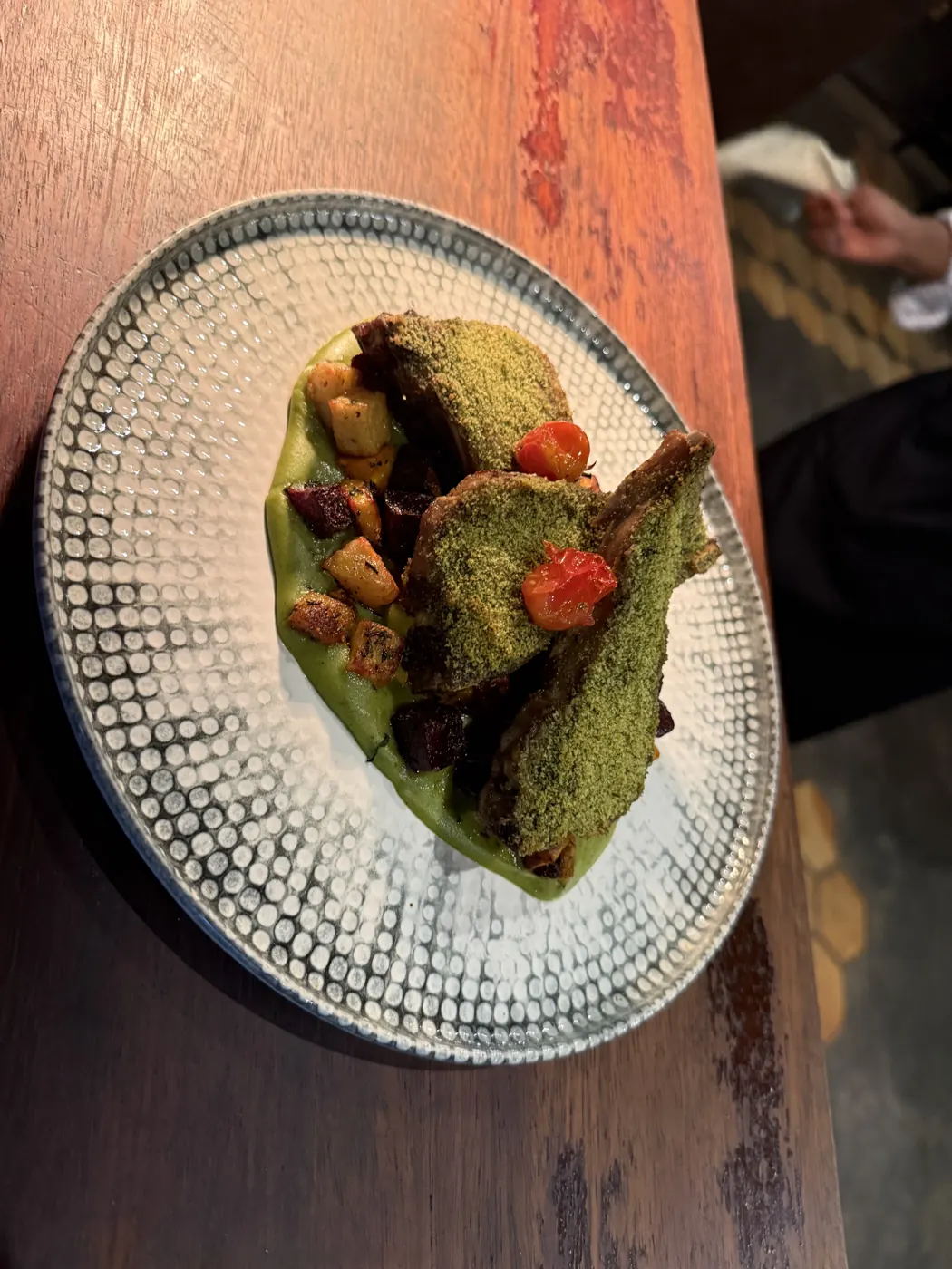 Herb-crusted lamb, vegetables, jus